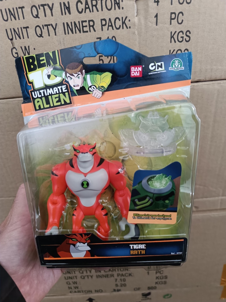 May include: A Ben 10 Ultimate Alien action figure of Tigre Rath, a red and white tiger-like alien, in a clear plastic package. The packaging features the Ben 10 logo, character art, and the text "Tigre Rath".