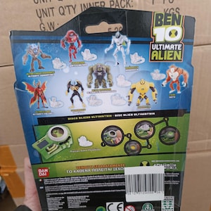 May include: Back of a Ben 10 Ultimate Alien toy package. The package features various action figures and the text "BEN 10 ULTIMATE ALIEN". The package also includes the text "DISCO BLIEND ULTIMATRIN DISC BLIEN ULTIMATRIN".