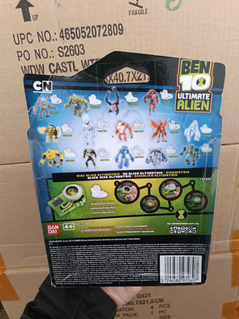 May include: A Ben 10 Ultimate Alien action figure package. The package features various alien figures and the Cartoon Network logo. The dimensions are 40.7 x 21 cm.
