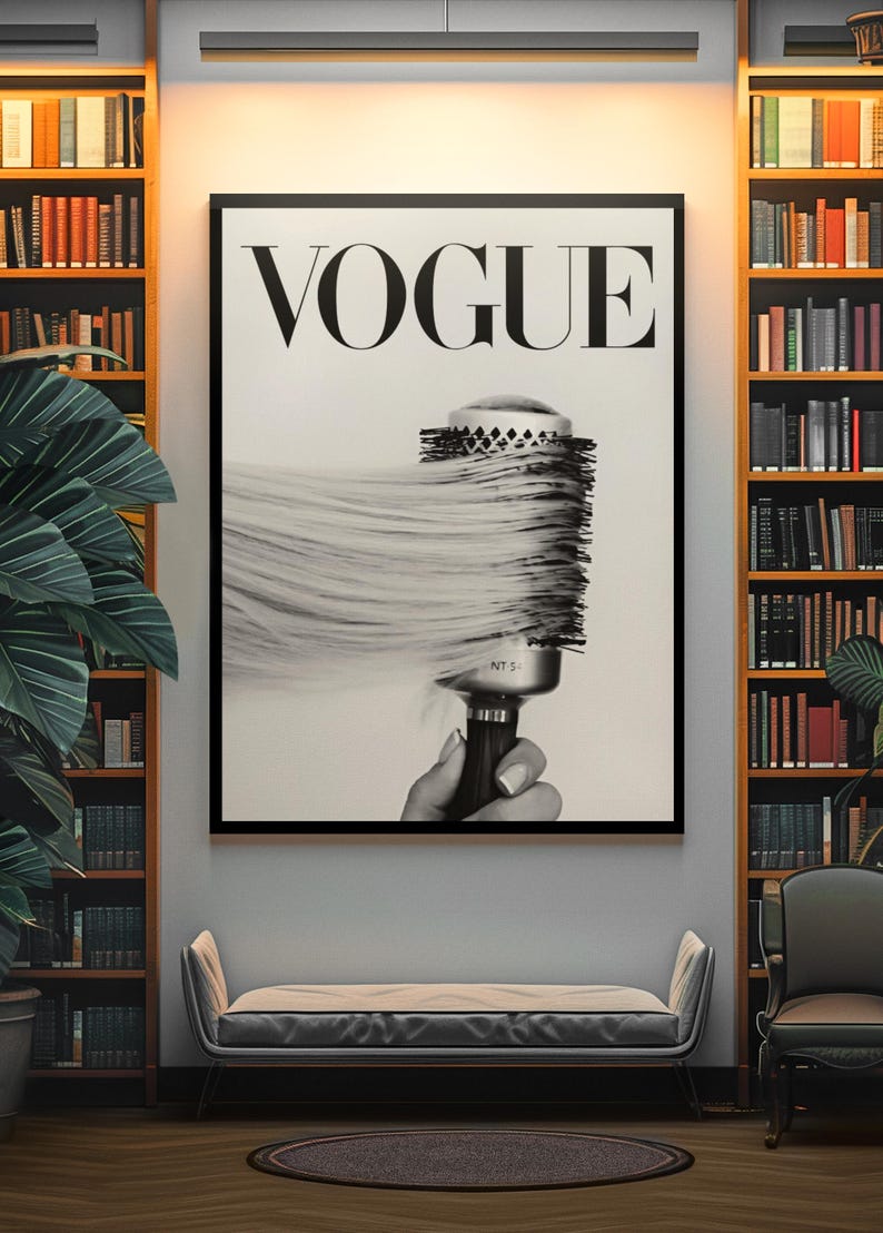 May include: Black and white Vogue magazine cover art print. The image features the Vogue logo and a hairbrush with flowing hair. The print is framed and displayed in a room with bookshelves and a bench.