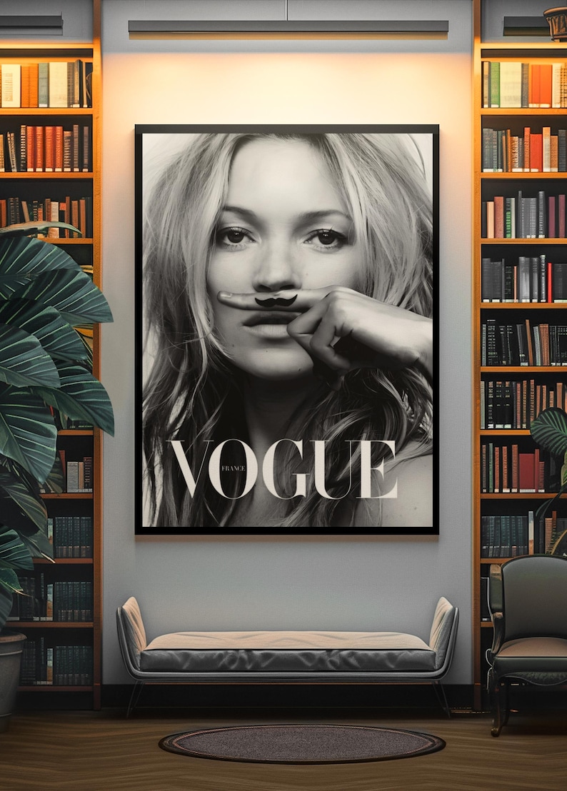May include: Monochrome framed Vogue poster featuring a woman with a drawn-on moustache. The poster is displayed in a room with bookshelves, a bench, and a chair. The word "VOGUE" is prominently displayed.