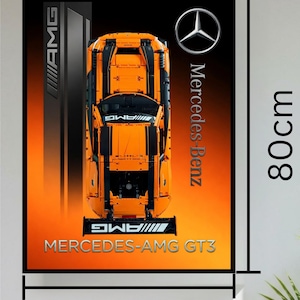 May include: A rectangular poster featuring a top-down view of an orange Mercedes-AMG GT3 race car model. The background transitions from black to orange. Text includes AMG, Mercedes-Benz, and MERCEDES-AMG GT3. Dimensions are 60cm by 80cm.