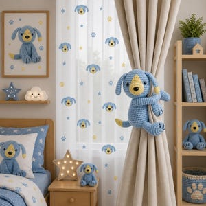 May include: A crochet blue dog curtain tieback with a yellow snout and black nose, featuring long floppy ears and limbs that wrap around a beige curtain. The design matches the blue dog theme seen in the framed wall art, pillows, and shelf decor.