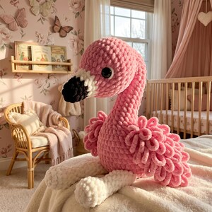 Pink flamingo stuffed animal displayed on nursery bed, handmade baby room decor