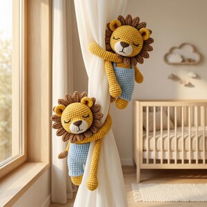 May include: Two crocheted lion curtain tiebacks featuring yellow bodies, brown manes, and light blue overalls. Each lion has closed eyes and a brown nose, with long arms wrapped around a white curtain to hold it in place securely.
