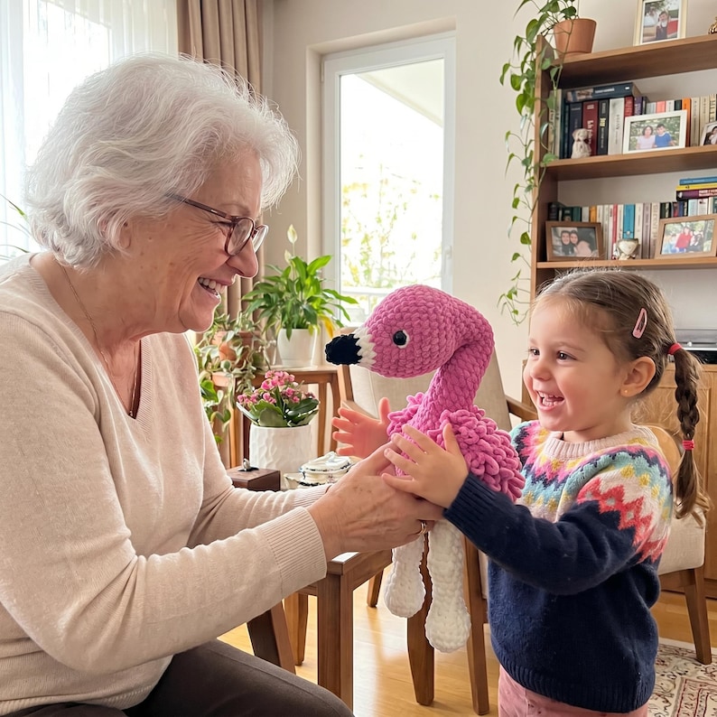 Grandmother gifting a handmade crochet flamingo plush toy to her granddaughter, unique baby girl gift