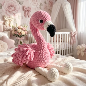 Handmade crochet flamingo plush toy in floral nursery, pink amigurumi bird decor for baby girl room