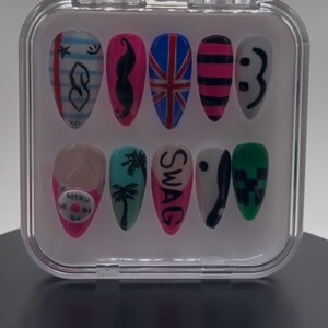 Könnte beinhalten: Ein Set aus zehn künstlichen Nägeln in einer transparenten Kunststoffbox. Jeder Nagel ist mit einem einzigartigen Design bemalt, darunter eine britische Flagge, ein Schnurrbart und das Wort "SWAG". Weitere Designs sind ein Smiley und ein Minecraft-Charakter.