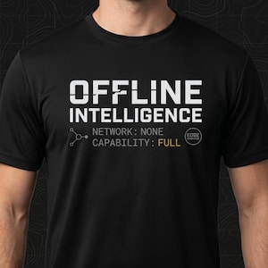 May include: Black t-shirt with the white text "OFFLINE INTELLIGENCE". Below the text are the words "NETWORK: NONE" and "CAPABILITY: FULL". A small graphic and the words "EDGE OPERATOR" are also visible.