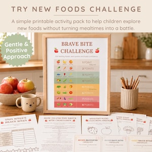 May include: A framed "Brave Bite Challenge" printable with a wooden frame, designed to help children explore new foods. The image includes apples, a mug, pencils, and additional printable sheets. The text reads "Try New Foods Challenge".