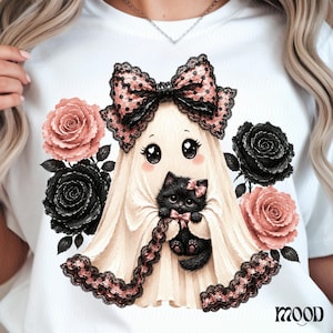May include: A white t-shirt featuring a graphic of a ghost wearing a large pink polka-dot bow and lace trim, holding a fluffy black kitten with a pink bow. The ghost is surrounded by two pink roses and two black roses. The word MOOD is printed below.