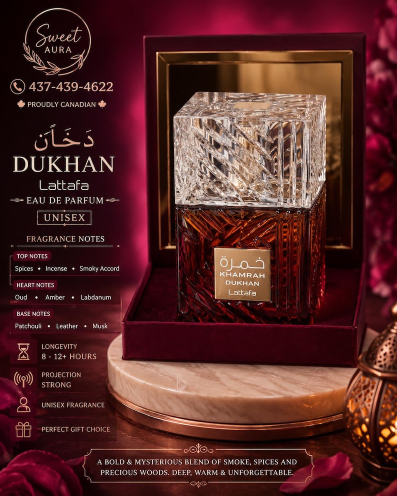 May include: A square glass perfume bottle with a textured, amber-colored base and a clear, faceted crystal-style cap. The bottle features a gold label with the text Khamrah Dukhan Lattafa. It is displayed inside an open, dark red velvet-lined box.