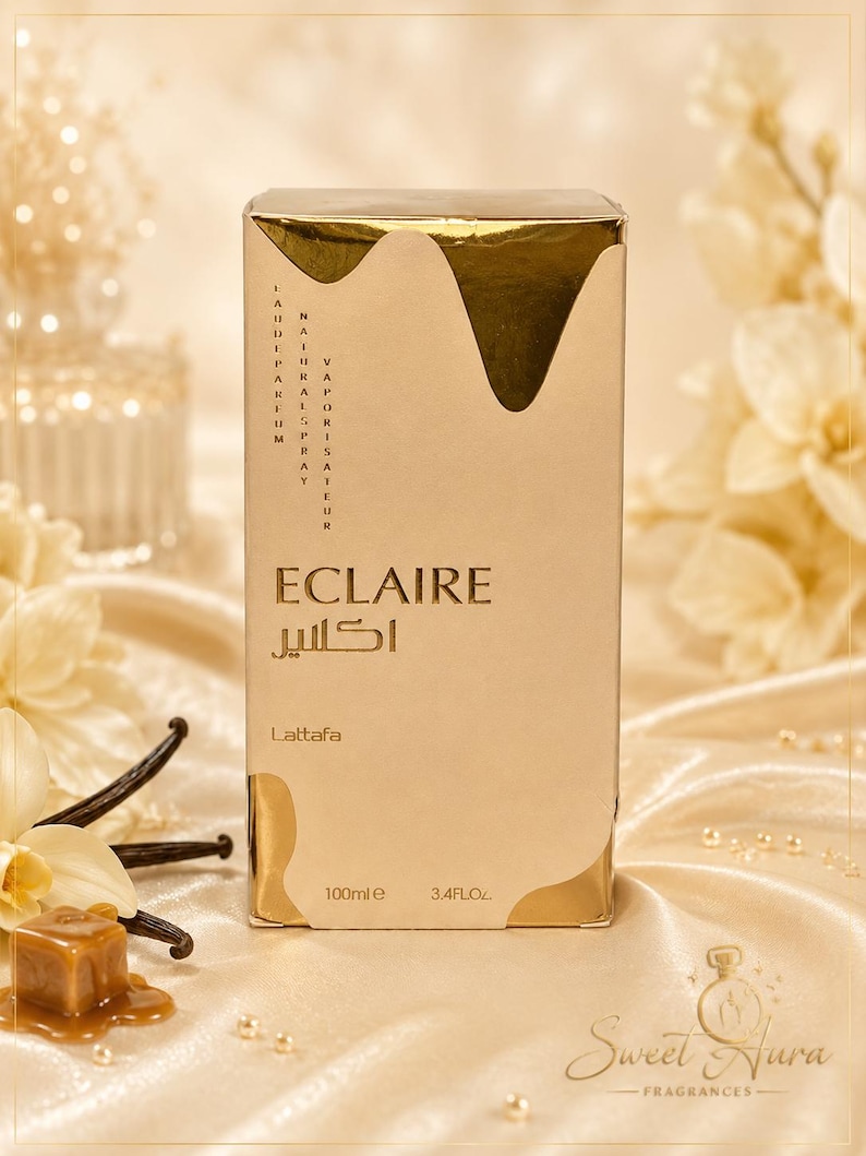 May include: A rectangular perfume box in beige and gold with a metallic drip design at the top. The text reads Eclaire, Lattafa, 100ml, 3.4FL.OZ, and includes Arabic script. The box features vertical text stating Eau de Parfum and Vaporisateur Natural Spray.
