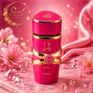 May include: A cylindrical hot pink perfume bottle with a gold cap and gold accents. The bottle features the text "YARA", "Lattafa", and "Candy" in gold lettering, along with Arabic script. The design includes a gold band wrapping around the center.