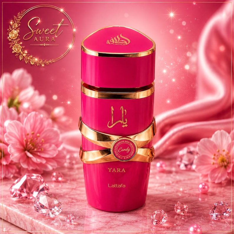 May include: A cylindrical hot pink perfume bottle with a gold cap and gold accents. The bottle features the text "YARA", "Lattafa", and "Candy" in gold lettering, along with Arabic script. The design includes a gold band wrapping around the center.