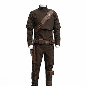May include: A brown costume displayed on a mannequin. The outfit includes a high-collared top, pants, and a belt with pouches. A brown leather strap crosses the chest. The costume is accented with white stitching and includes a holster and leg wraps. Black boots complete the look.