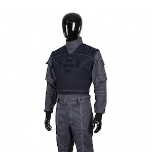 May include: A dark blue and gray uniform displayed on a mannequin. The uniform includes a high-collared shirt, a vest with a geometric design, and matching pants. White stitching accents the seams. Black gloves complete the outfit.
