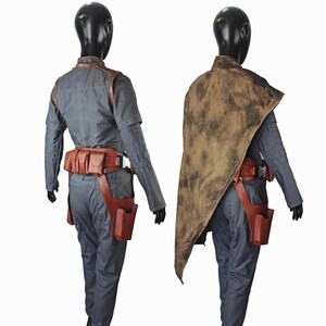 May include: A gray long-sleeved shirt and pants set worn with a brown leather utility belt featuring multiple pouches and a holster. One view includes a distressed brown cape draped over the shoulder, while the other shows the belt and shirt details.