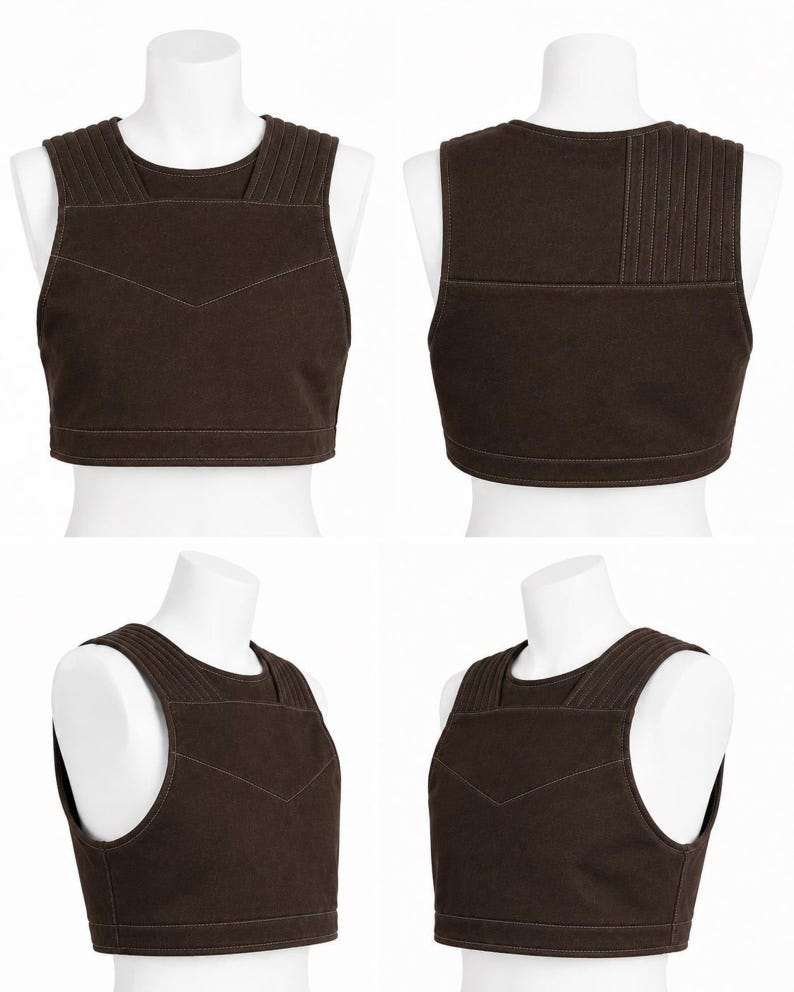 May include: A brown vest displayed on a white mannequin. The vest has a rounded neckline and a series of vertical stitched lines on the shoulders. A decorative stitched design is on the front. The vest is made of a sturdy material.