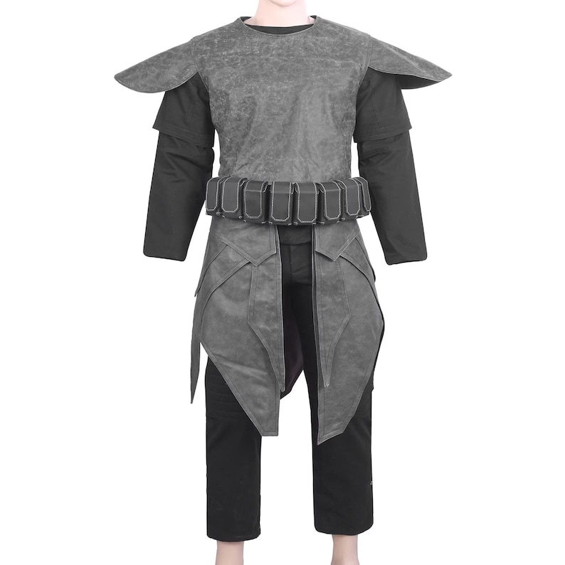 May include: A gray textured tunic with shoulder pauldrons and a black utility belt featuring multiple rectangular pouches. The garment is worn over a black long-sleeved shirt and black trousers, creating a layered appearance with a structured design.