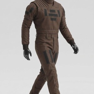 May include: Brown jumpsuit with black accents, featuring a high collar and quilted shoulder design. The outfit includes matching pants and long sleeves, with black gloves. The mannequin is walking on a brown platform.