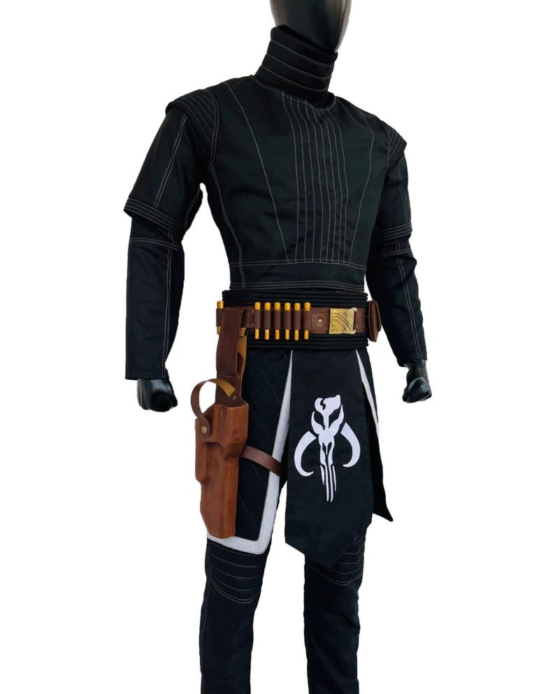 May include: Black costume with white stitching, high collar, and a belt with gold details. Includes a holster and a black skirt with a white emblem. The outfit is displayed on a mannequin.
