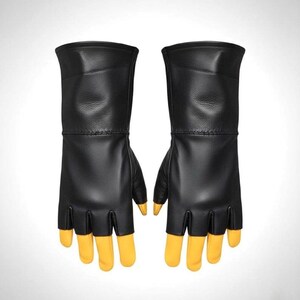 May include: A pair of fingerless gloves featuring black leather construction on the back of the hand and wrist, with contrasting yellow leather fingers that extend past the black leather cutouts. The gloves have a long cuff design.