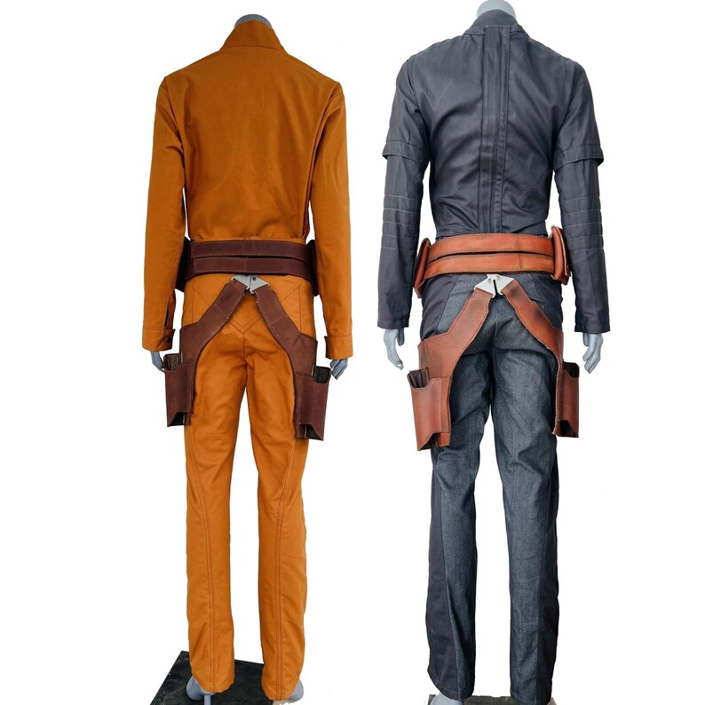 May include: Two full-body outfits displayed on mannequins from the back. One outfit is solid orange with a brown leather-style belt and holster system. The second outfit is solid dark gray with a matching brown leather-style belt and holster.