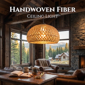 May include: A woven fiber ceiling light fixture hangs in a rustic living room. The light is a warm, golden color and is suspended from the ceiling. The text "HANDWOVEN FIBER CEILING LIGHT" is displayed above the light.