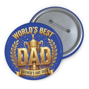 May include: A blue button with the text "WORLD'S BEST DAD" in gold, featuring a trophy and laurel leaves. The text "FATHER'S DAY 2026" is also included. A second button is visible in the background.