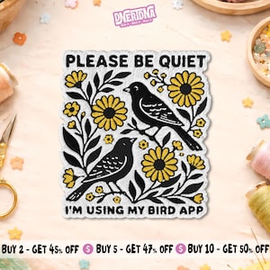 May include: A rectangular embroidered patch featuring two black birds perched among yellow flowers and black leaves. The text PLEASE BE QUIET is at the top and I'M USING MY BIRD APP is at the bottom in black capital letters on a white background.