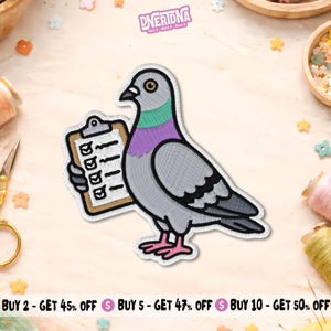 May include: An embroidered iron-on patch featuring a grey pigeon with a green and purple neck, holding a tan clipboard with a white paper checklist containing four black checkmarks. The design has a thick black outline and a white border.