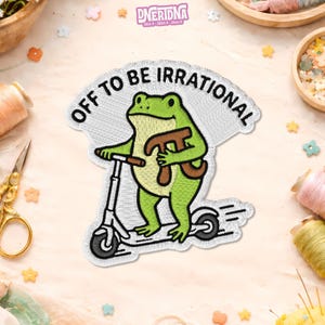 May include: Embroidered patch with a green frog on a scooter, holding a pi symbol. The text "OFF TO BE IRRATIONAL" is arched above. The frog and scooter are outlined in black, on a white background.
