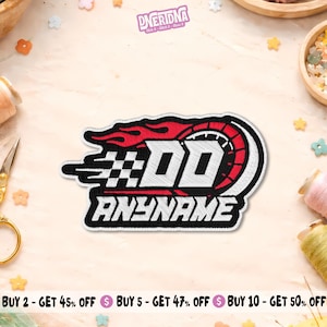 May include: An embroidered patch featuring a racing-themed design with red flames, a black and white checkered pattern, and a tire graphic. The text DD and ANYNAME are stitched in white with black outlines on a black background with white borders.