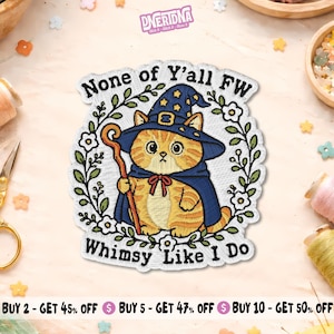 May include: An embroidered patch featuring an orange tabby cat dressed as a wizard in a blue hat and cape, holding a wooden staff. The cat is surrounded by a floral wreath and the text "None of Y'all FW Whimsy Like I Do" in black thread.