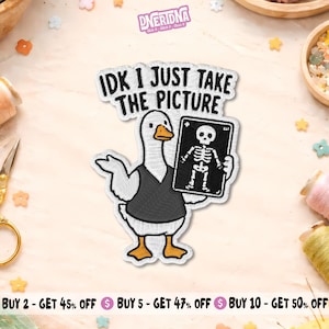 May include: Embroidered patch featuring a white goose wearing a black vest, holding an X-ray image of a skeleton. The text "IDK I JUST TAKE THE PICTURE" is above the goose. The patch has a stitched border.