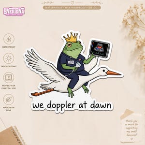 Peut inclure: Un autocollant découpé représentant une grenouille verte portant une couronne dorée et une tenue médicale bleu marine, chevauchant une cigogne blanche. La grenouille tient une sonde et un écran d'échographie. Texte : we doppler at dawn.
