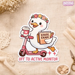 May include: A sticker depicting a cartoon duck with a floral crown, holding a coffee cup and a book marked "STATE EXAM." The duck is riding a pink scooter, with the words "OFF TO ACTIVE MONITOR" beneath. The design has a charming, playful aesthetic.