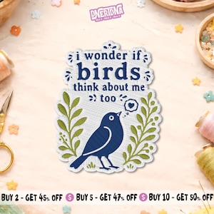 May include: A white embroidered patch featuring a dark blue bird and green leafy branches. The text reads, "i wonder if birds think about me too," with a small speech bubble containing a heart above the bird. The patch has a scalloped edge.
