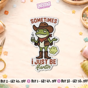 May include: An embroidered patch featuring a green frog wearing a brown cowboy hat, vest, and boots, holding a cup. The text reads "SOMETIMES i JUST BE Fartin". The frog has a red bandana and a green cloud graphic behind it, with white borders.