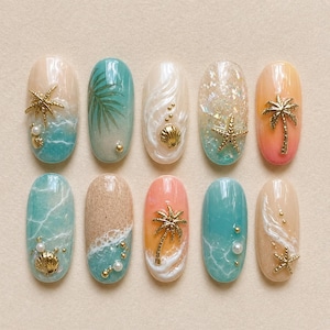 May include: A collection of ten oval-shaped nail designs featuring beach-themed art. Designs include ocean waves, palm trees, seashells, and starfish, with accents of gold and pearls. The nails are painted in shades of blue, beige, and coral.