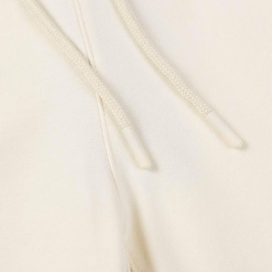May include: A pair of off-white cotton sweatpants featuring a thick, woven drawstring cord in a matching cream color. The drawstring ends are finished with smooth, cylindrical plastic aglets that provide a clean and secure closure detail.