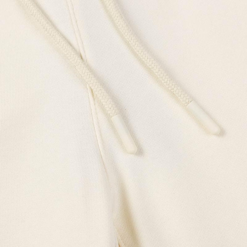 May include: A pair of off-white cotton sweatpants featuring a thick, woven drawstring cord in a matching cream color. The drawstring ends are finished with smooth, cylindrical plastic aglets that provide a clean and secure closure detail.