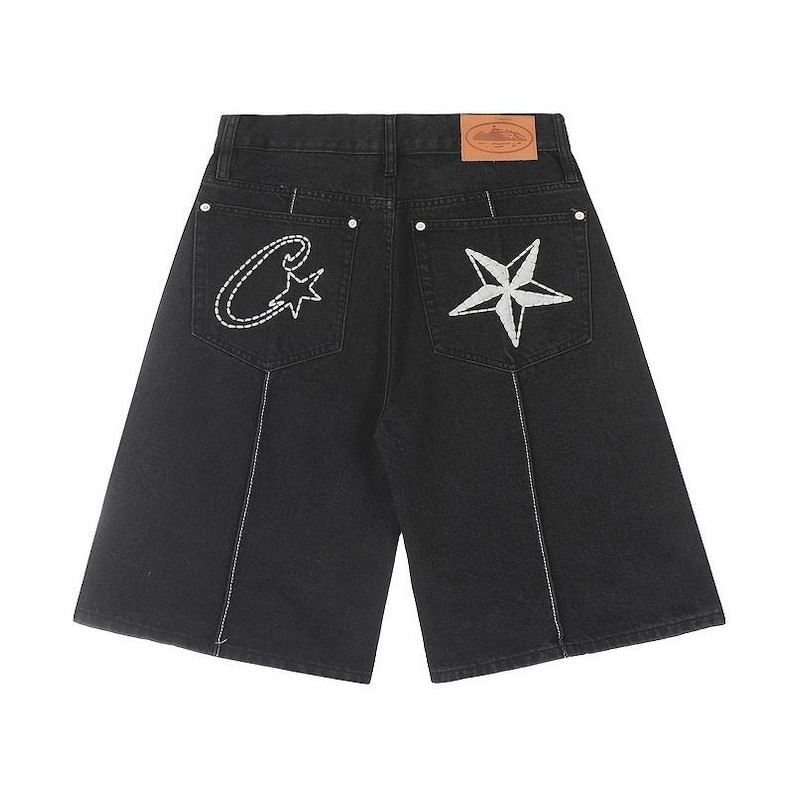 May include: Black denim shorts featuring a high-waist design with a tan leather patch on the back waistband. The back pockets are embroidered with a white stitched letter C and a star on the left, and a large white star on the right pocket.