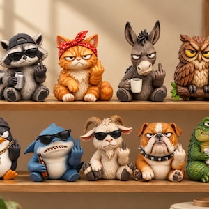 May include: A collection of eight animal figurines arranged on two shelves. The figures include a raccoon, orange cat, donkey, owl, penguin, shark, goat, bulldog, and crocodile, each displaying a middle finger gesture.