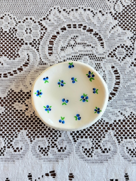 Hand-painted blueberry ceramic dish with cottagecore charm that's specific enough to feel genuinely personal — 22 favorites confirms real demand for the look.