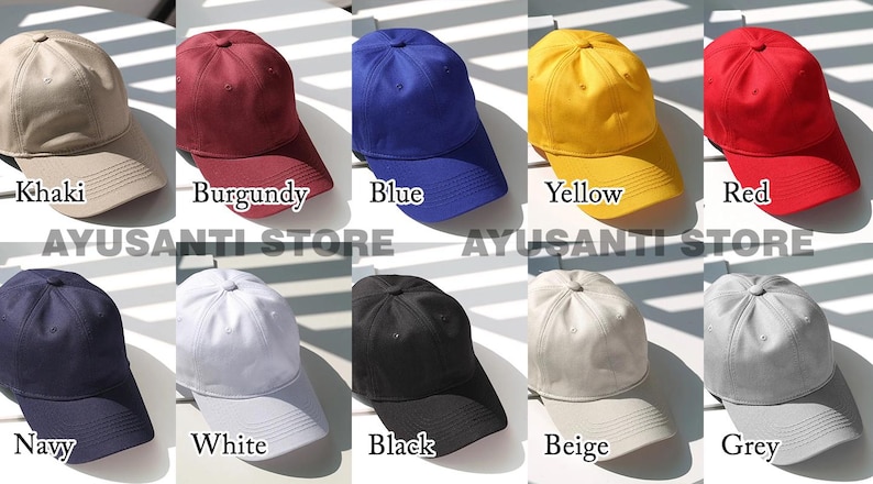 May include: A collection of baseball caps in various colors, including khaki, burgundy, blue, yellow, red, navy, white, black, beige, and grey. Each cap has a curved brim and a fabric crown. The text "AYUSANTI STORE" is visible.