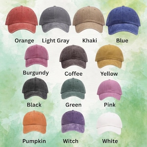 May include: A collection of fourteen baseball caps in various colors, each labeled with text: Orange, Light Gray, Khaki, Blue, Burgundy, Coffee, Yellow, Black, Green, Pink, Pumpkin, Witch, and White. The caps feature a solid, washed-out fabric texture.