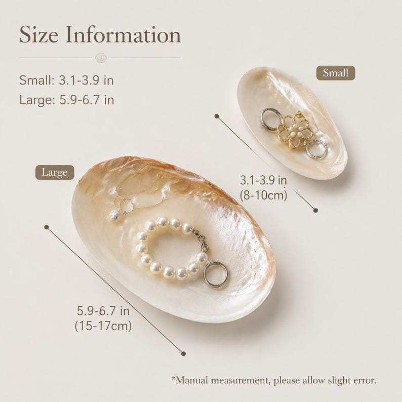May include: Two oval-shaped mother-of-pearl shell dishes for jewelry. The small dish measures 3.1-3.9 inches and holds a gold-toned floral charm. The large dish measures 5.9-6.7 inches and contains a white pearl bracelet and a silver ring.
