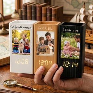 May include: Three rectangular digital clocks in white, light wood, and black finishes. Each clock features a vertical photo display with custom text: Our favorite memories, Dad & Me, and I love you. The digital time is displayed in yellow LED.